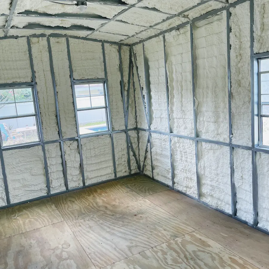 Closed-cell spray foam insulation applied to wall cavities in a residential project in Elmhurst